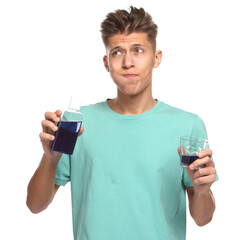 Canvas Print - Young man using mouthwash on white background