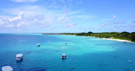 Wall Mural - Scenic view of boats in the tranquil Indian Ocean near the beautiful beach on a summer day