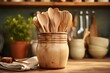 Wooden kitchen utensils in bowl on table, closeup