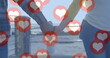 Image of red heart icons floating over mid section of couple in love holding hands by seaside