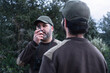 Man talking with walkie talkie radio - Park Ranger Team for Wildfire Prevention