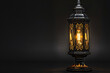 a vintage lantern mounted on a wall, with an antique design and glass enclosure The lantern, reminiscent of traditional street lamps, provides soft illumination and adds a retro touch 