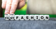 Hand turns dice and changes the expression 'fast fashion' to 'slow fashion'.