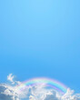Blue sky and rainbow message board background - ideal for spiritual holistic or holiday advert template with clouds and a rainbow along the bottom plus copy space above for text content