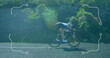 Image of frame over caucasian man riding bike