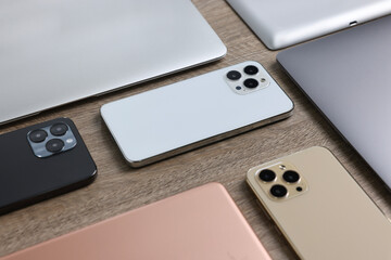 Many different modern gadgets on wooden table