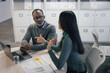 © ReeldealHD images - Mature African American businessman listening to a financial advisor in a business meeting