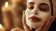 Close-up of a serene woman with a luxurious facial mask, capturing a moment of self-care and beauty treatment in a tranquil setting.