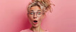A surprised mature woman with glasses and big hair on a pink background, conveying emotions of shock and amazement.