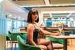 © unai - Sensual african woman drinking wine in a luxury restaurant