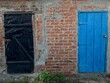 Two old doors black and blue colour in the countryside.
