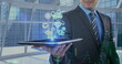 Image of digital icons over businessman holding tablet