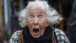 A old woman surprised with a big open mouth and blue eyes. She is wearing a scarf and a purse. a 100-year old white woman looks shocked and aghast