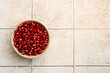 Tasty ripe pomegranate grains on tiled table, top view. Space for text