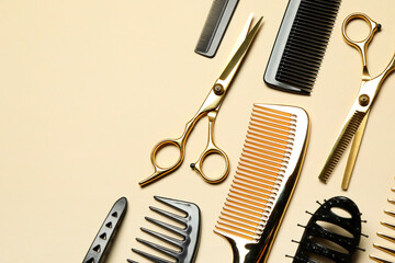 Wall Mural - Hairdressing tools on beige background, flat lay. Space for text