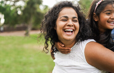 Wall Mural - Happy indian mother having fun with her daughter outdoor - Family, mom day and love concept - Focus on mum face