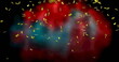 Image of gold confetti floating over out of focus red and black background