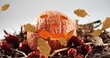 Image of orange autumn leaves falling over pumpkin