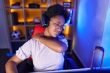 Fototapeta Koty - African american woman streamer stressed suffering for backache at gaming room