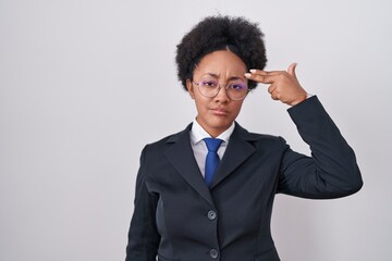 Canvas Print - Beautiful african woman with curly hair wearing business jacket and glasses shooting and killing oneself pointing hand and fingers to head like gun, suicide gesture.