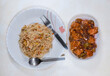 Tasty Chinese cuisine of chicken fried rice with boneless chilli chicken on white background