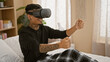 Wakeful morning in the bedroom - young, confident latin man sporting a smile while chillin' in his apartment, playing a 3d car video game with sleek virtual reality glasses indoors