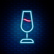 Glowing neon line Wine glass icon isolated on brick wall background. Wineglass sign. Colorful outline concept. Vector