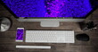 Image of technological devices with light spots on screen on desk