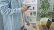 © Krakenimages.com - Smartphone savvy young hispanic man harnesses power of internet at business office, embodies successful professional worker portrait