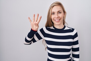 Wall Mural - Young caucasian woman wearing casual navy sweater showing and pointing up with fingers number four while smiling confident and happy.