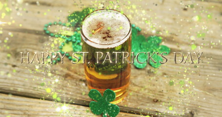 Poster - Image of st patrick's day text, shamrock and glass of beer on wooden background