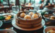 Dim sum steamed buns in bamboo steamer - Traditional Chinese dim sum delicacy, juicy steamed buns served in bamboo steamer on a wooden table
