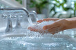 A person using a gentle hand soap to wash their hands, with water flowing softly, promoting hand hygiene