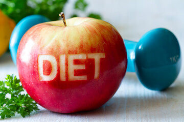 Wall Mural - Red apple with cut-out word diet and dumbbell, diet and healthy lifestyle concept