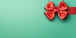 Red ribbon with bow on mint green background, Christmas card concept. Space for text. Red and Mint Green Background