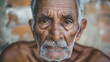 Elderly man with striking eyes, reflecting a life of experience and resilience.