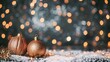 Sparkling golden Christmas ornaments resting on snow with a bokeh light background, festive holiday concept.