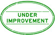 Grunge green under improvement word oval rubber seal stamp on white background