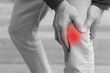 Middle aged old man hand holding knee joint pain, concept of osteoporosis, thin bone, osteoarthritis; gout, knee bone joint injury problem issue concept image, with red alert highlight