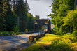 Rusty steel bridge surrounded by greenery near Forks, Washington