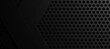 A black background with a black grid of hexagons.Design for sports background and technology background.
