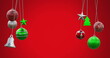 Image of hanging baubles, tress, bell swinging against red background