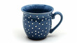 Blue ceramic polka-dotted mug on white background