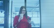 Image of financial data over caucasian businesswoman with coffee and smartphone in office
