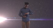 Image of african american businessman using smartphone over glowing stars