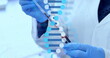 Image of dna strand over scientist with test tube