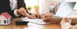 © Pormezz - Hand of landlord, realtor pointing sign signature contract rental, purchase, buyer home or apartment with tenant, client after banker agreement mortgage, loan success or done. Property agent concept.