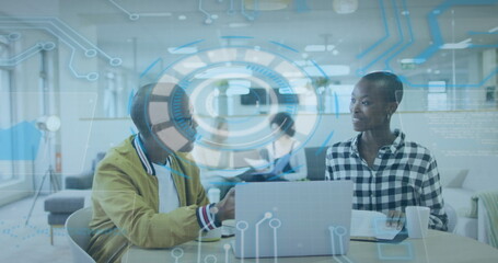 Canvas Print - Image of data processing over african american male and female colleagues discussing at office