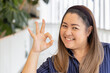 Middle aged woman showing yes, approving, accepting ok for all correct hand gesture