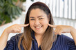 Happy smiling middle aged asian woman with sincere smile, pointing fingers to her face, positive friendly expression